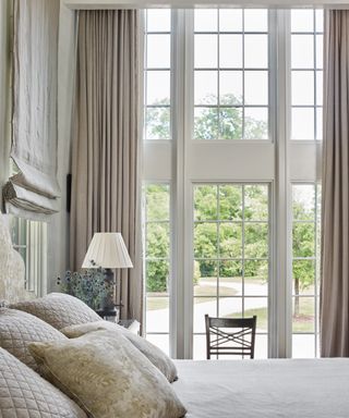 Large window curtain ideas with grey linen curtains in a bedroom