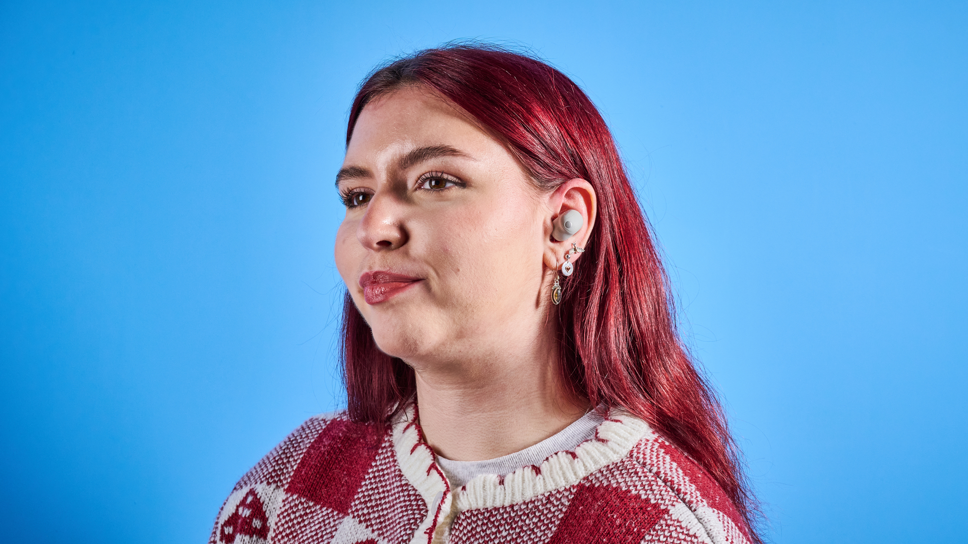 Sony WF-1000XM6 earbuds photographed in front of a blue background