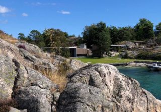 Cabin Lillesand a norwegian summer house out of wood in the shores of a north sea fjord