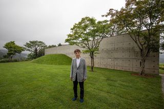 space of light pavilion by tadao ando with the architect standing in front