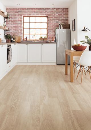 light wood plant flooring in white kitchen