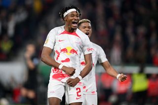 Mohamed Simakan of RB Leipzig celebrates after Dominik Szoboszlai of RB Leipzig (not pictured) scores the team's fifth goal from a penalty kick during the DFB Cup semifinal match between Sport-Club Freiburg and RB Leipzig at Europa-Park Stadion on May 02, 2023 in Freiburg im Breisgau, Germany.