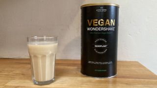 Image of Vegan Wondershake mixed in a glass and packaging