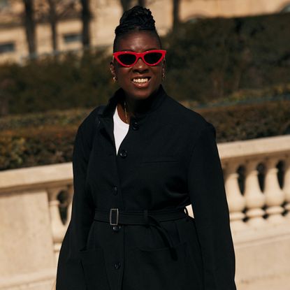 Nikki Ogunnaike wearing a black coat and a white T-shirt