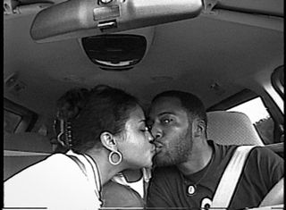 Sibil Fox Richardson and Rob Richardson kiss in their car.