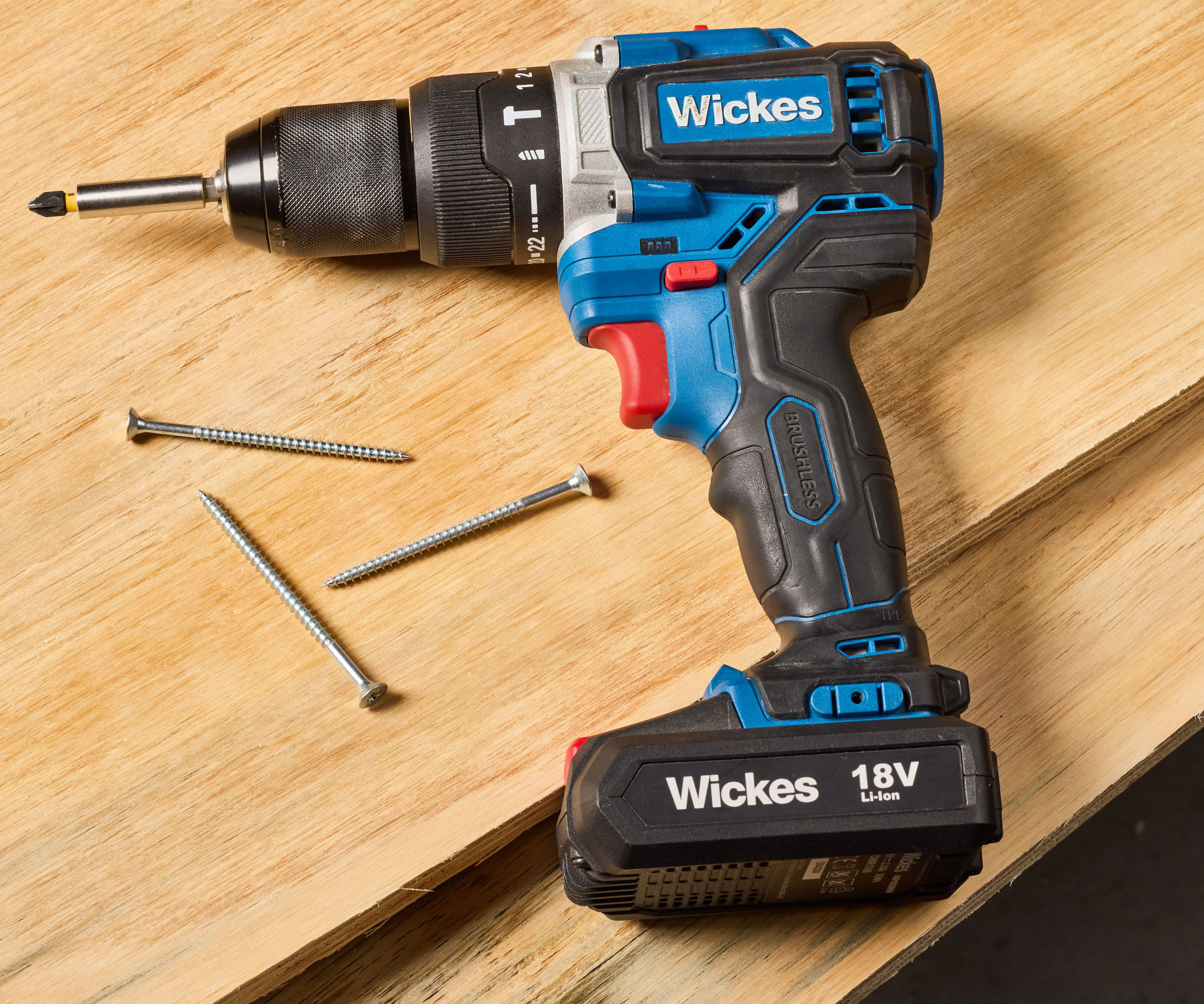 Blue cordless drill on top of sheets of plywood