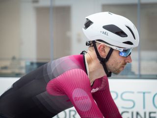 Tom riding in the wind tunnel wearing an aero helmet