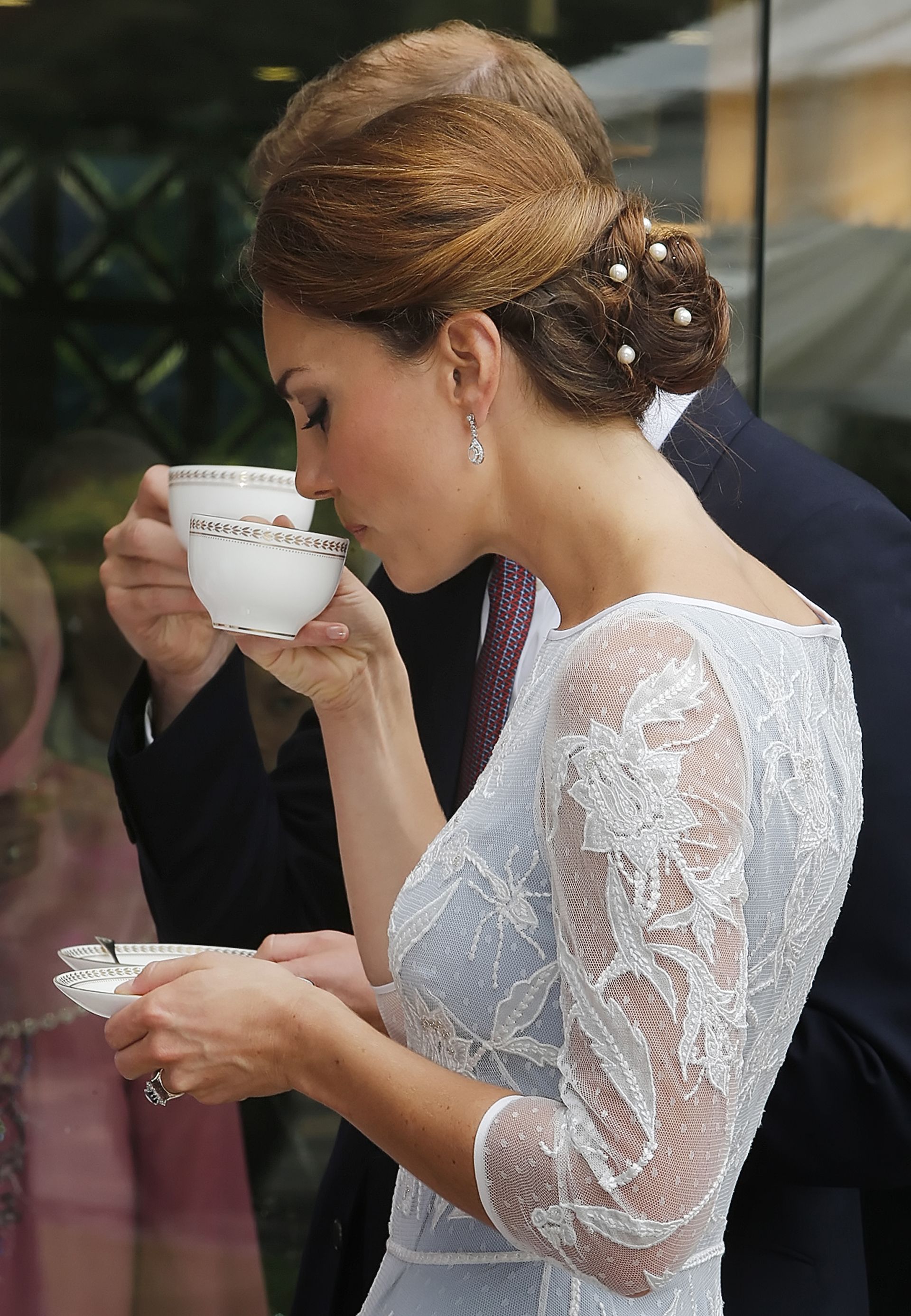The Duke and Duchess of Cambridge drink tea during a Diamond Jubilee Tea Party at the British High Commission in Kuala Lumpur, as part of a nine-day tour of the Far East and South Pacific, in honour of the Queen's Diamond Jubilee.