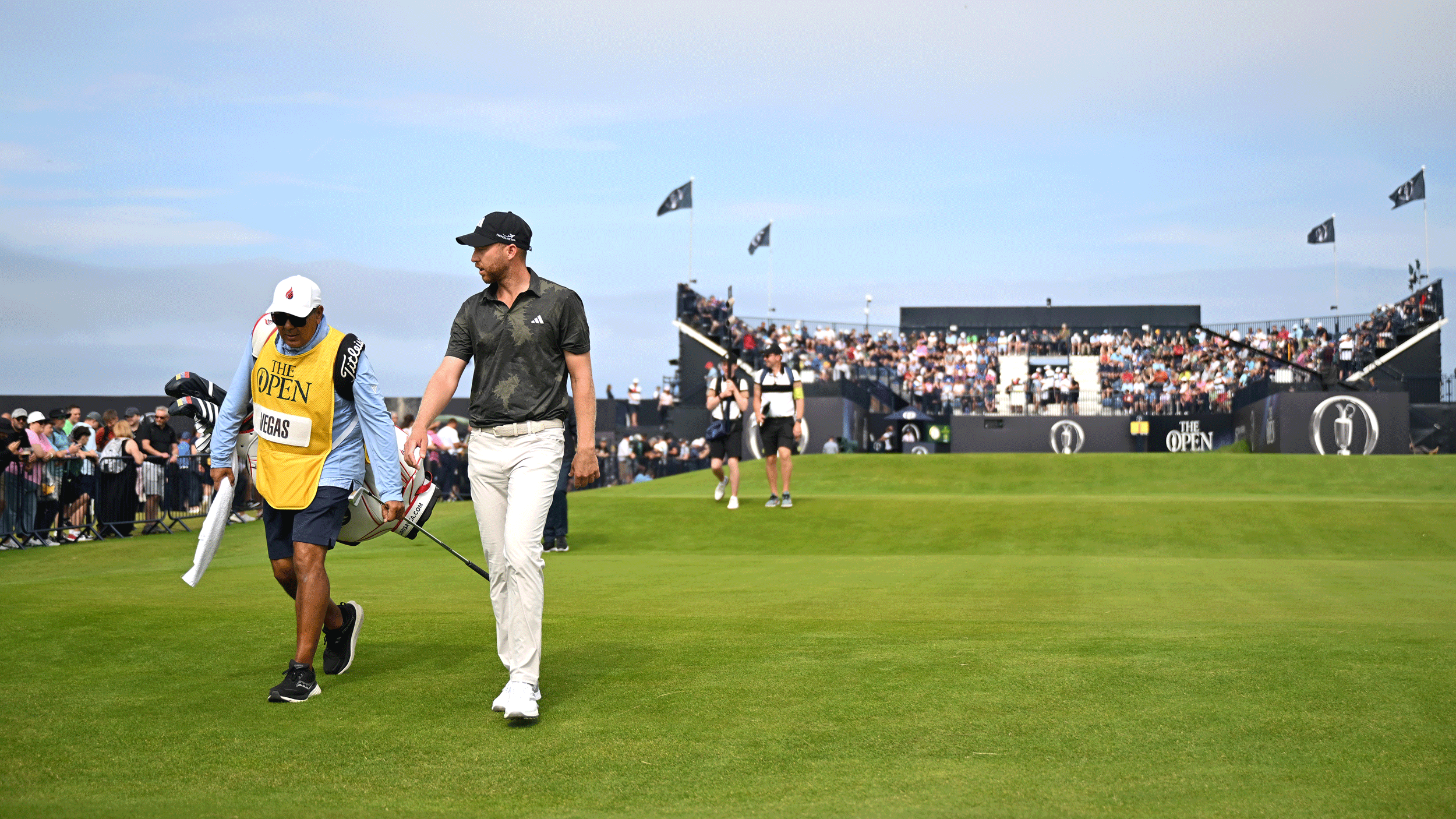 Daniel Berger walks off the first tee during The Open Championship at Royal Portrush in 2025