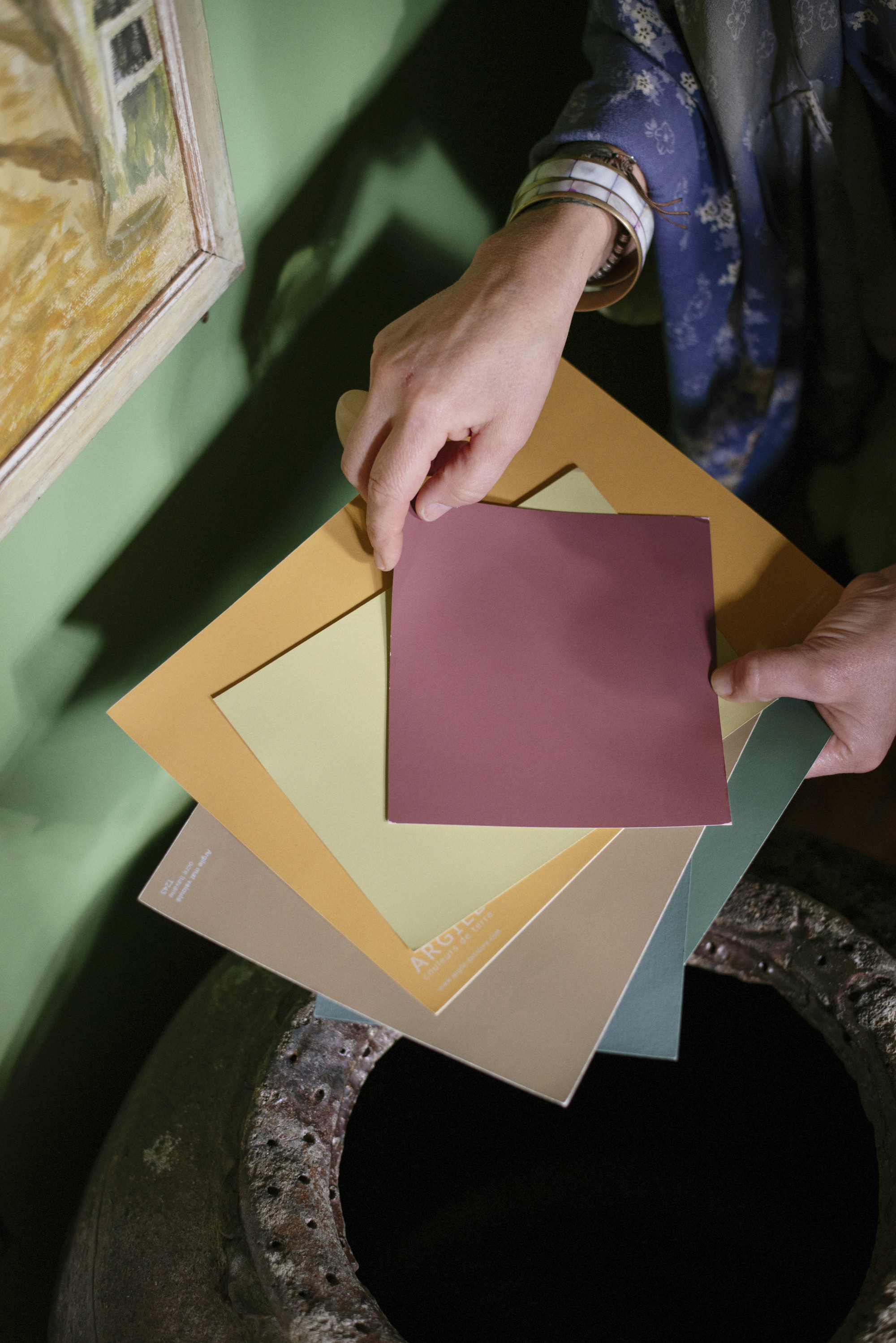 close up of colour cards next to a green wall
