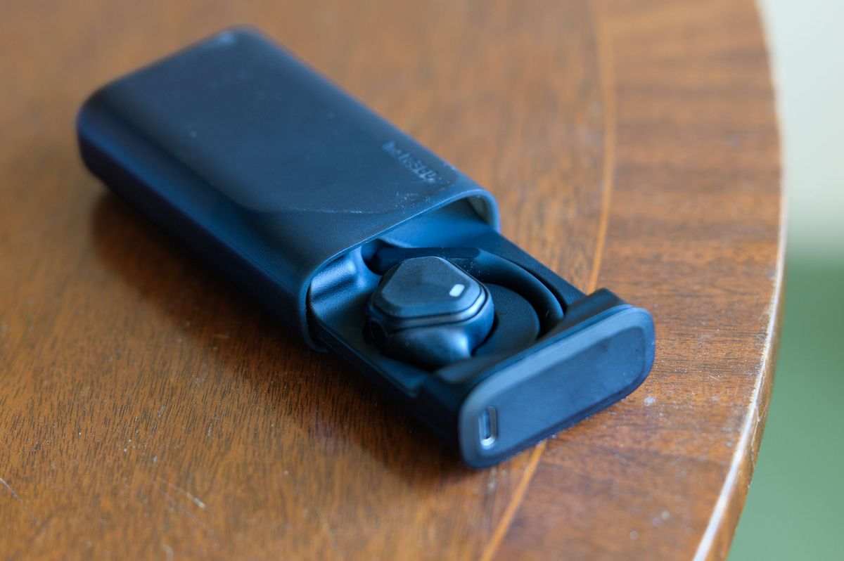 Insta360 POV Head Tracker accessory in its hard shell battery case on a mahogany table