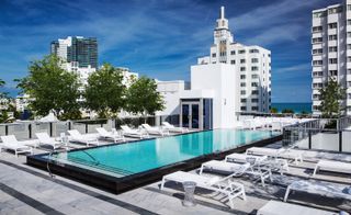 Rooftop pool with white skyscrapers surrounding