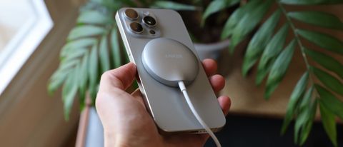 Anker MagGo Wireless Charging Pad attached to an iPhone 15 Pro Max and held in a hand