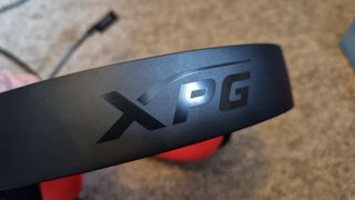 The headband of the XPG Precog Studio gaming headset, showing the XPG logo.