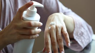 young woman applying eczema to help with her eczema