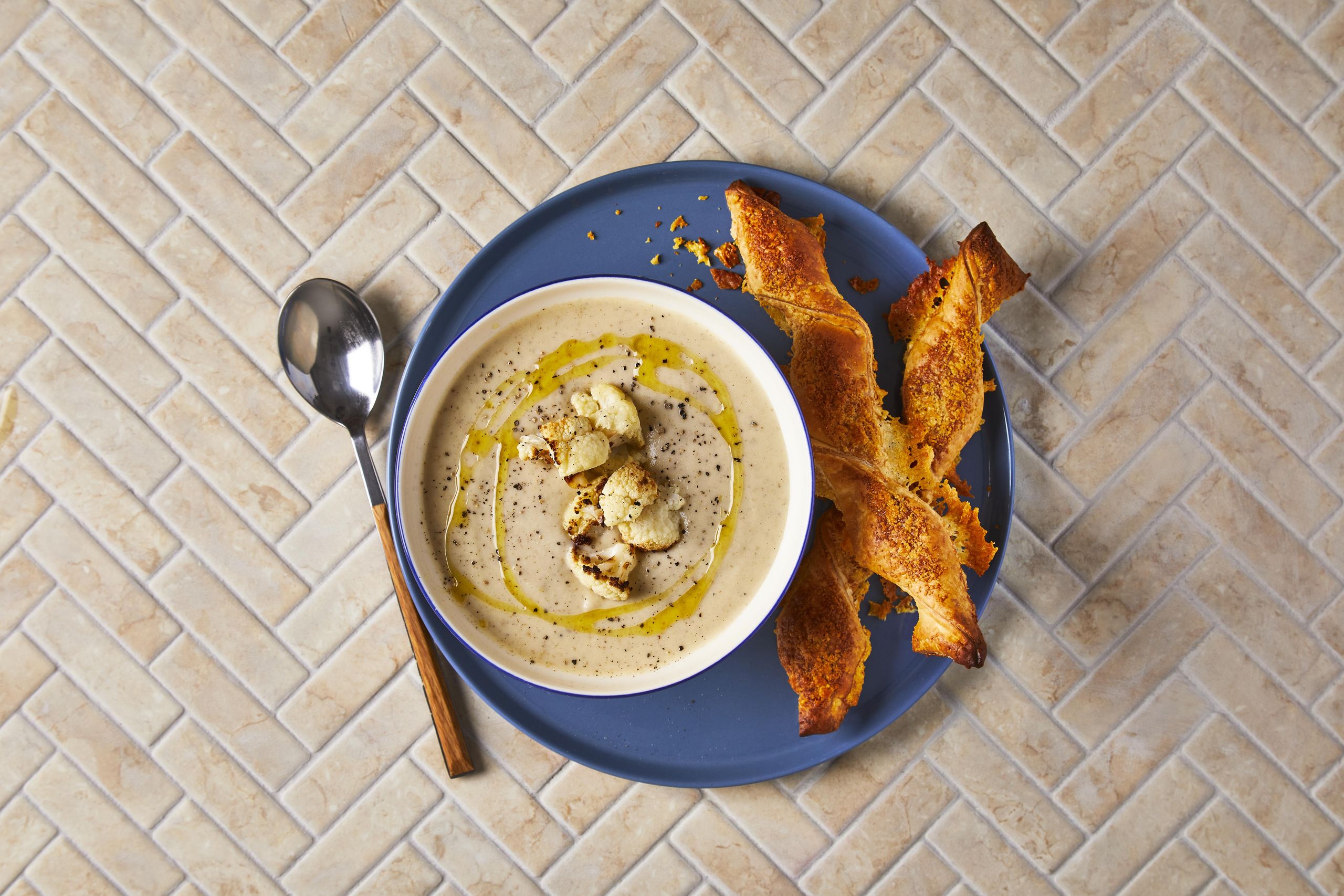 spcied cauliflower soup with cheese puff on the side