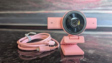 The Razer Kiyo V2 webcam pictured on a dark marble worksurface.