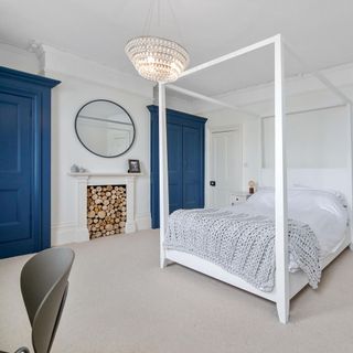 Bedroom with white wall and four poster bed