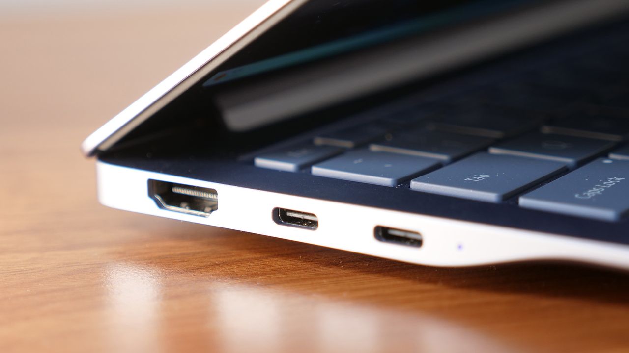 Close up photo of left ports on Samsung Galaxy Book 4 Edge on a wooden table.