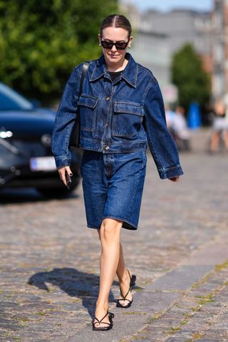 Woman wearing denim jacket and jorts at CPFW GettyImages-2165786038