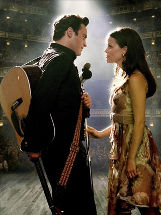 joaquin phoenix as johnny cash and reese witherspoon as june carter on stage in the movie walk the line