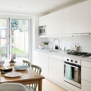 kitchen with cabinet and white wall