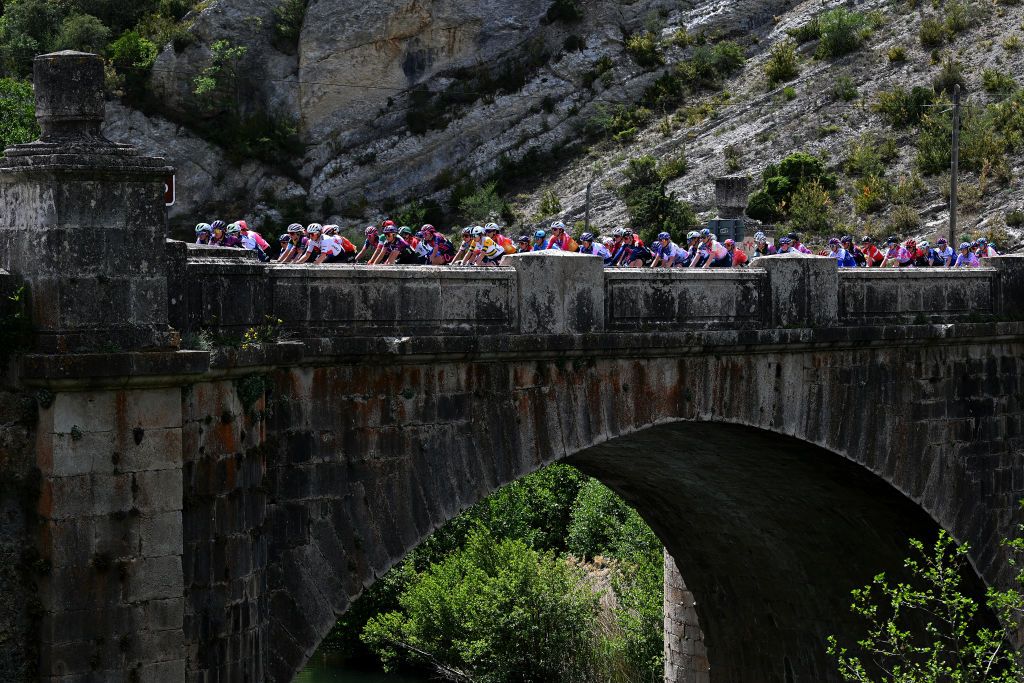 MEDINA DE POMAR SPAIN MAY 18 A general view of the peloton passing through a bridge during the 8th Vuelta a Burgos Feminas 2023 Stage 1 a 1156km stage from Quintanaortuo to Medina de Pomar UCIWWT on May 18 2023 in Medina de Pomar Spain Photo by Dario BelingheriGetty Images