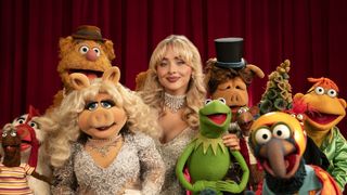 Sabrina Carpenter posing for a photograph alongside The Muppets for The Muppet Show Special on Disney+