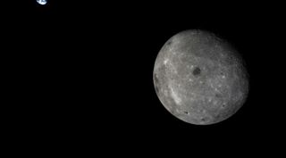 The far side of the moon and distant Earth, imaged by China's Chang'e 5 T1 mission service module in 2014. The Chang'e 4 mission will launch toward the far side on Dec. 7, 2018.