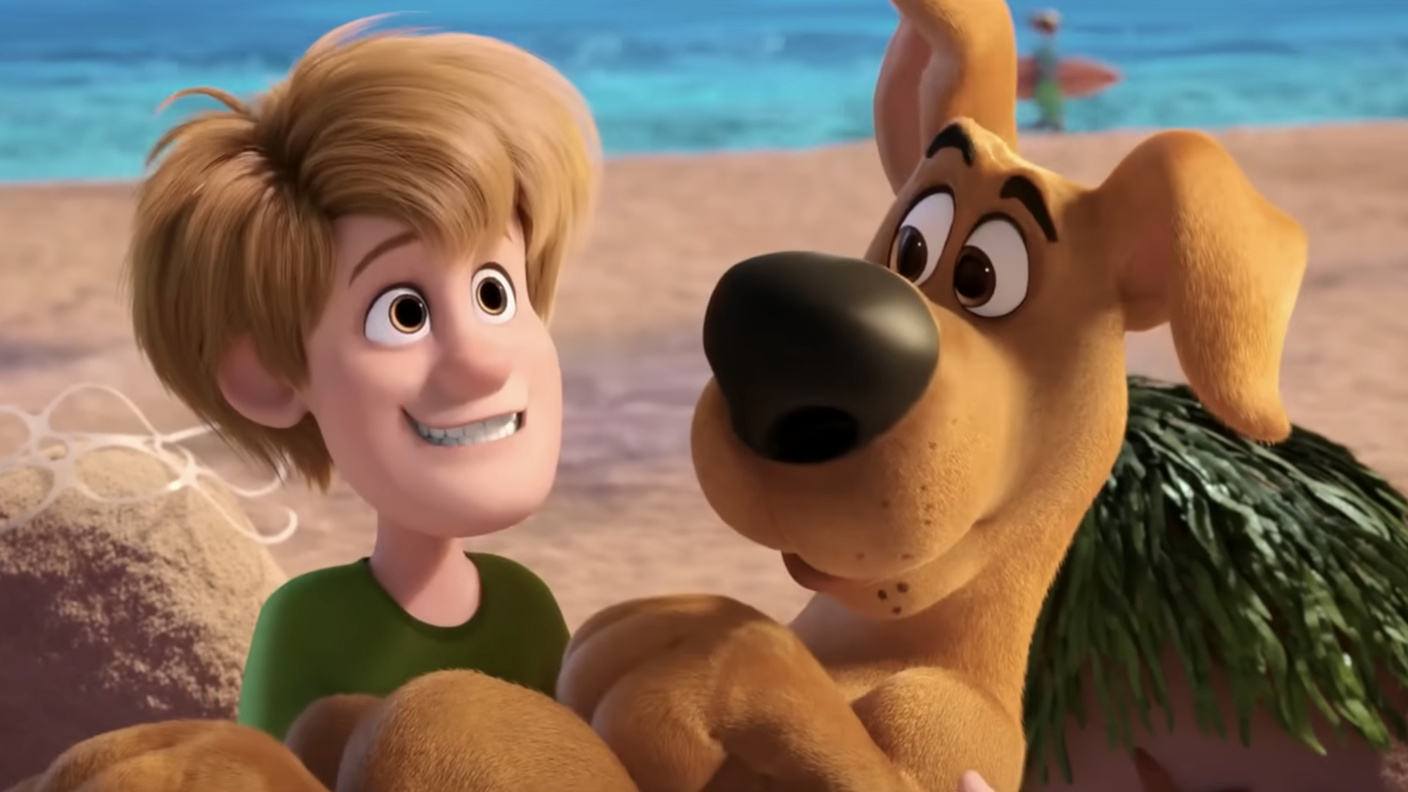 Shaggy Rogers (Iain Armitage) and Scooby-Doo (Frank Welker) chill on the beach in Scoob!.