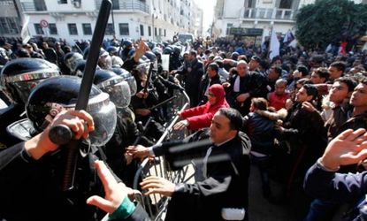 Tunisian protesters clash with riot police a day after the death of opposition leader Chokri Belaid.