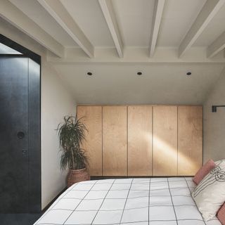 bedroom with bespoke storage built into the eaves