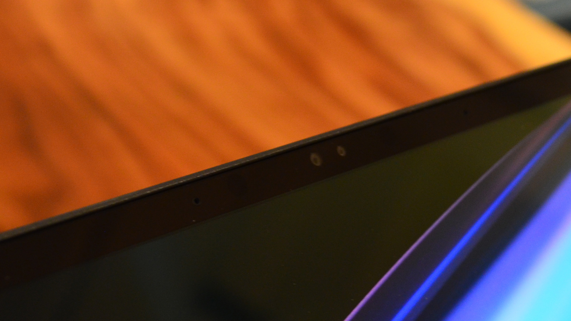 An Asus Zenbook Pro 16X OLED on a wooden table