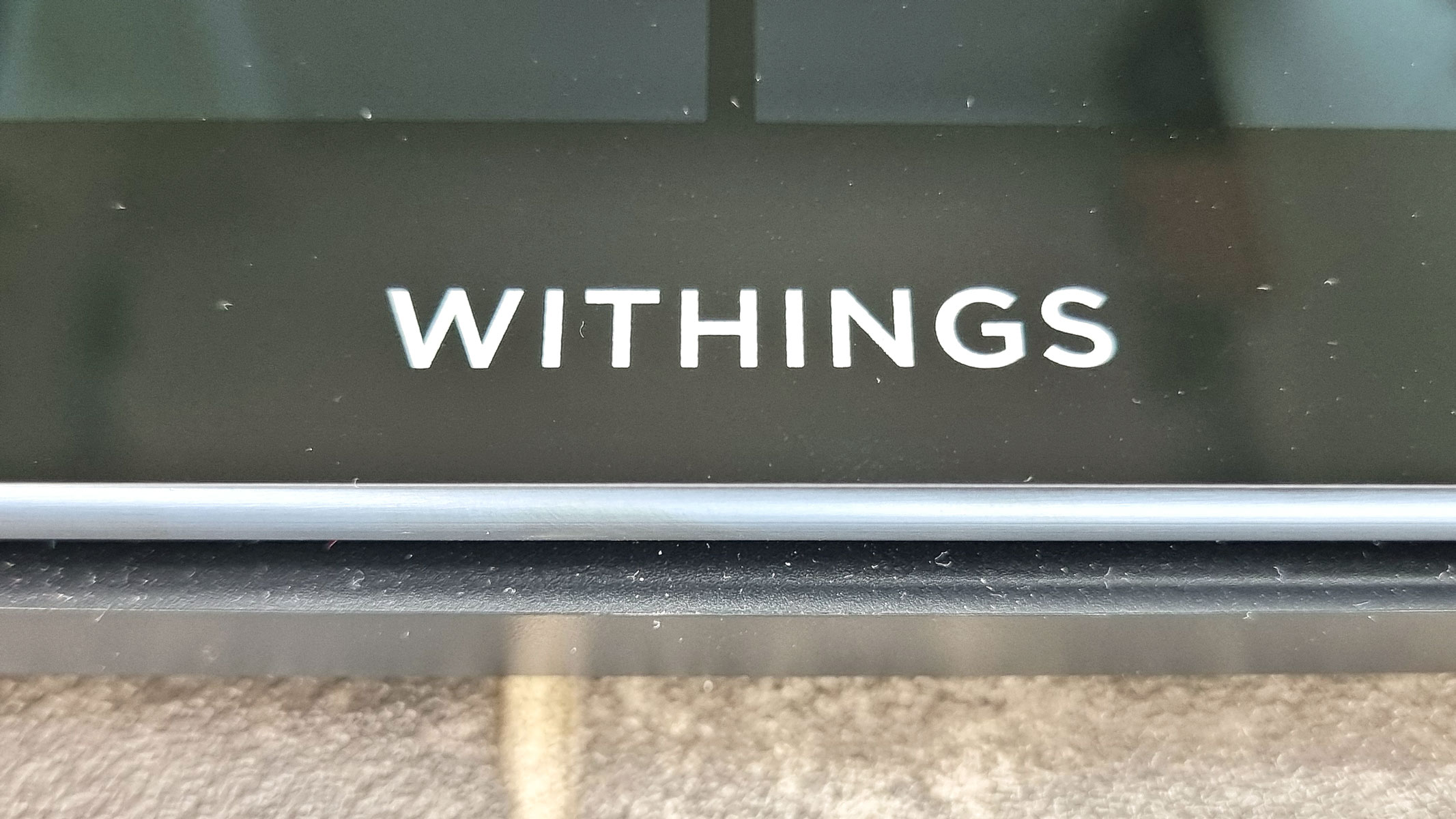 a close-up picture of the glass surface of the Withings Body Scan smart scale