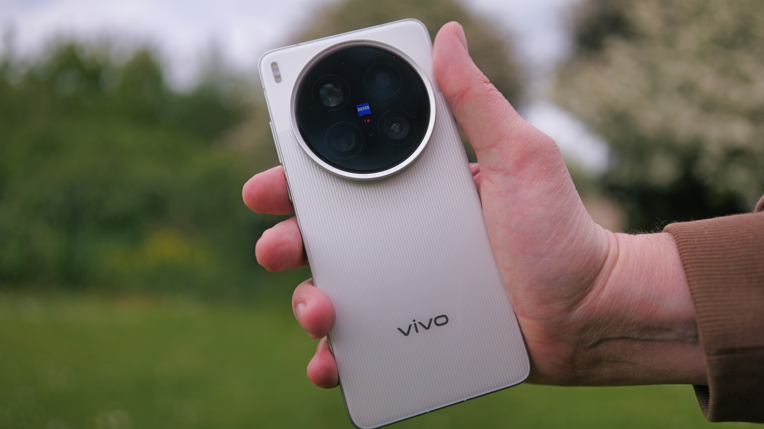 Vivo X200 Ultra phone held in a pair of hands outside