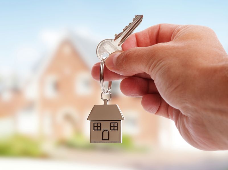 A man holding a house key.