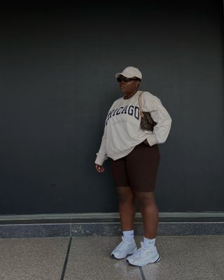 Influencer wears long shorts and trainers.