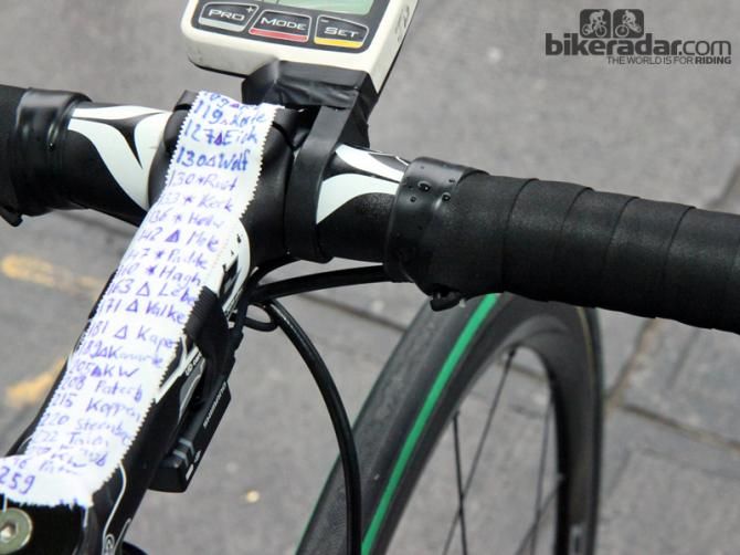 More supplemental shift buttons are positioned up top on John Degenkolb's (Giant-Shimano) Giant Defy Advanced SL. His course notes are so long that they overflow on to the headset cap and stem faceplate. A strip of tape provides a little insurance for his SRM computer, too