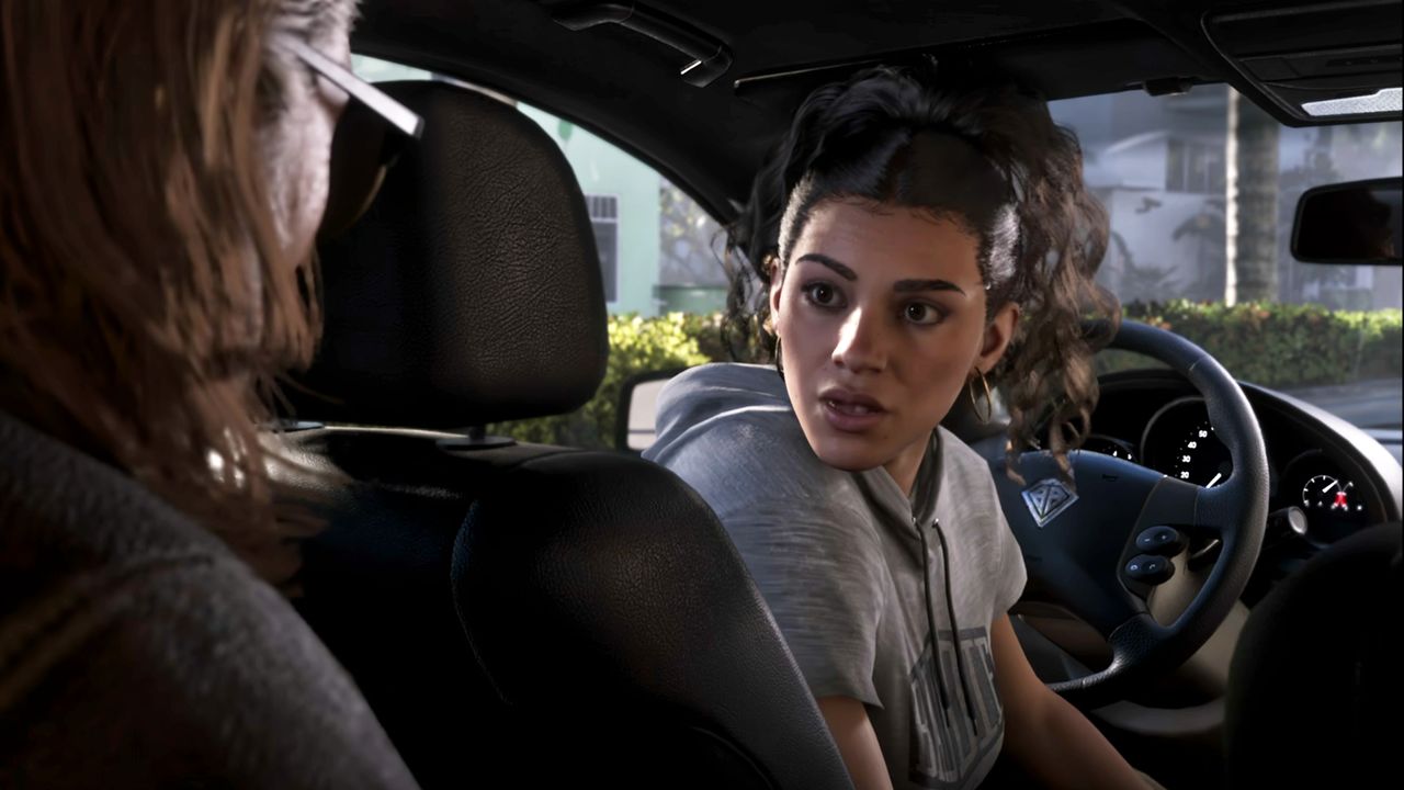 A screenshot of the GTA 6 Extended Look. Lucia sits in the driver's seat of a car and turns back toward a man in the backseat.