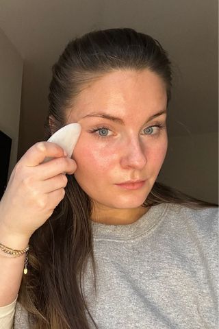 Gua sha routine - Tori Crowther showing how to use the side of the tool on the cheek