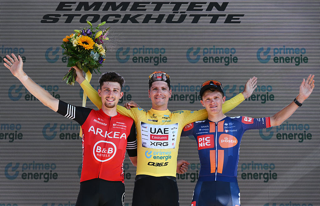 STOCKHUTTE, SWITZERLAND - JUNE 22: (L-R) Kevin Vauquelin of France and Team Arkea - B&B Hotels on second place, race winner Joao Almeida of Portugal and UAE Team Emirates - XRG - Yellow leader jersey and Oscar Onley of Great Britain and Team Picnic PostNL on third place pose on the podium ceremony after the 88th Tour de Suisse 2025, Stage 8 a 10km individual time trial stage from Beckenried to Stockhutte 1268m / #UCIWT / on June 22, 2025 in Stockhutte, Switzerland. (Photo by Tim de Waele/Getty Images)