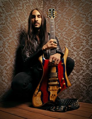 Dario Lorina poses with a Wylde Audio electric guitar