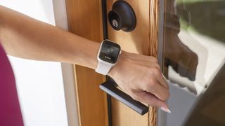 Level Touch Plus smart lock in use with an Apple Watch