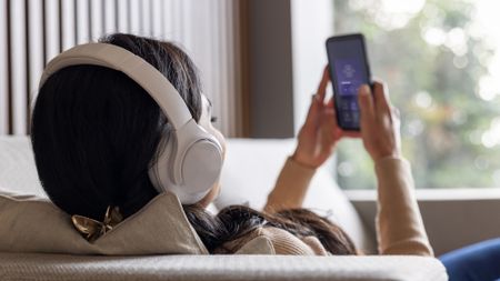 Woman listening to music via smartphone streaming
