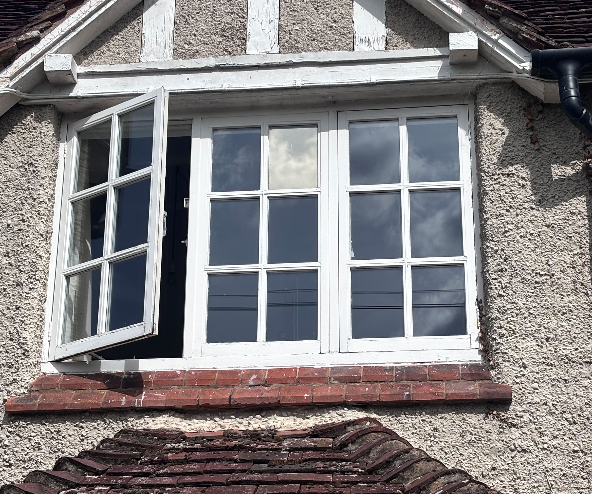 timber casement window with one pane fitted with solar control window film