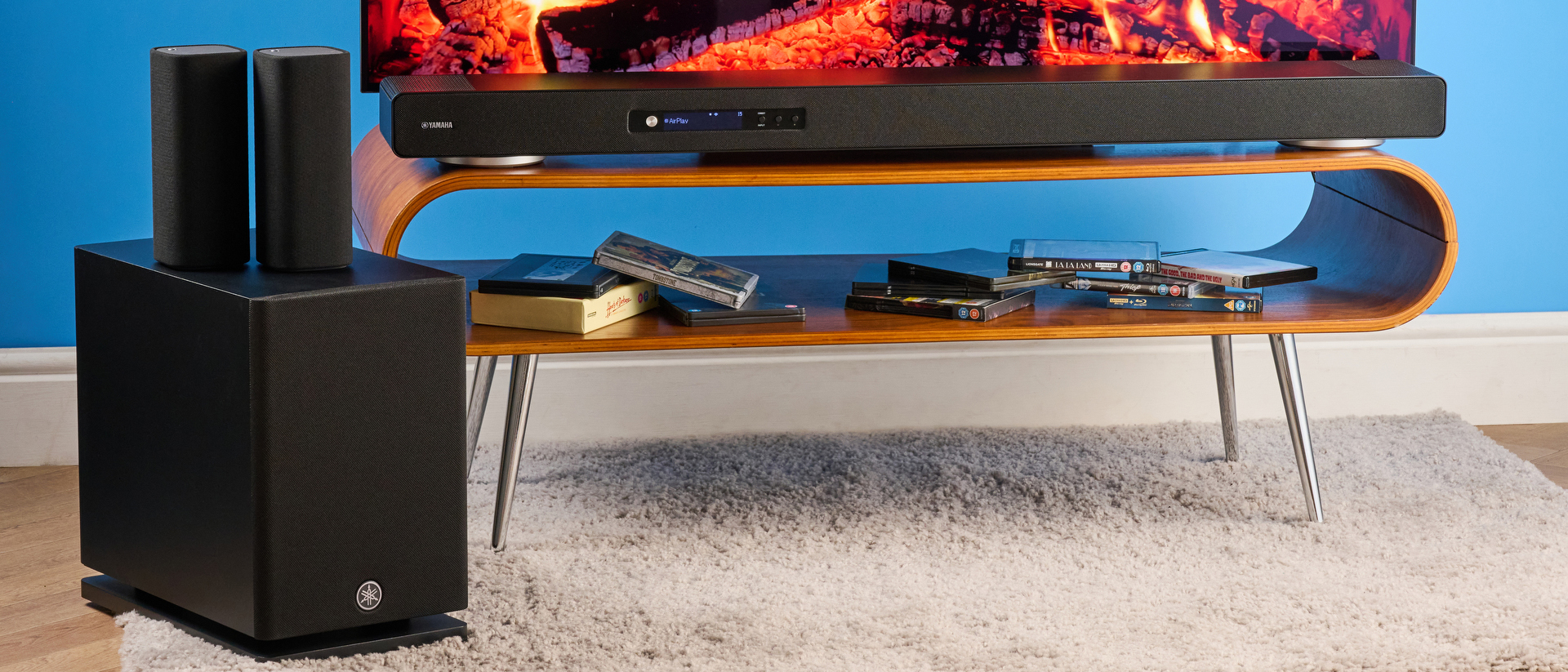 the yamaha true x surround 90a soundbar with dolby atmos, subwoofer, surround rear wireless speakers, and a 5.1.4 channel configuration photographed alongside a TV 