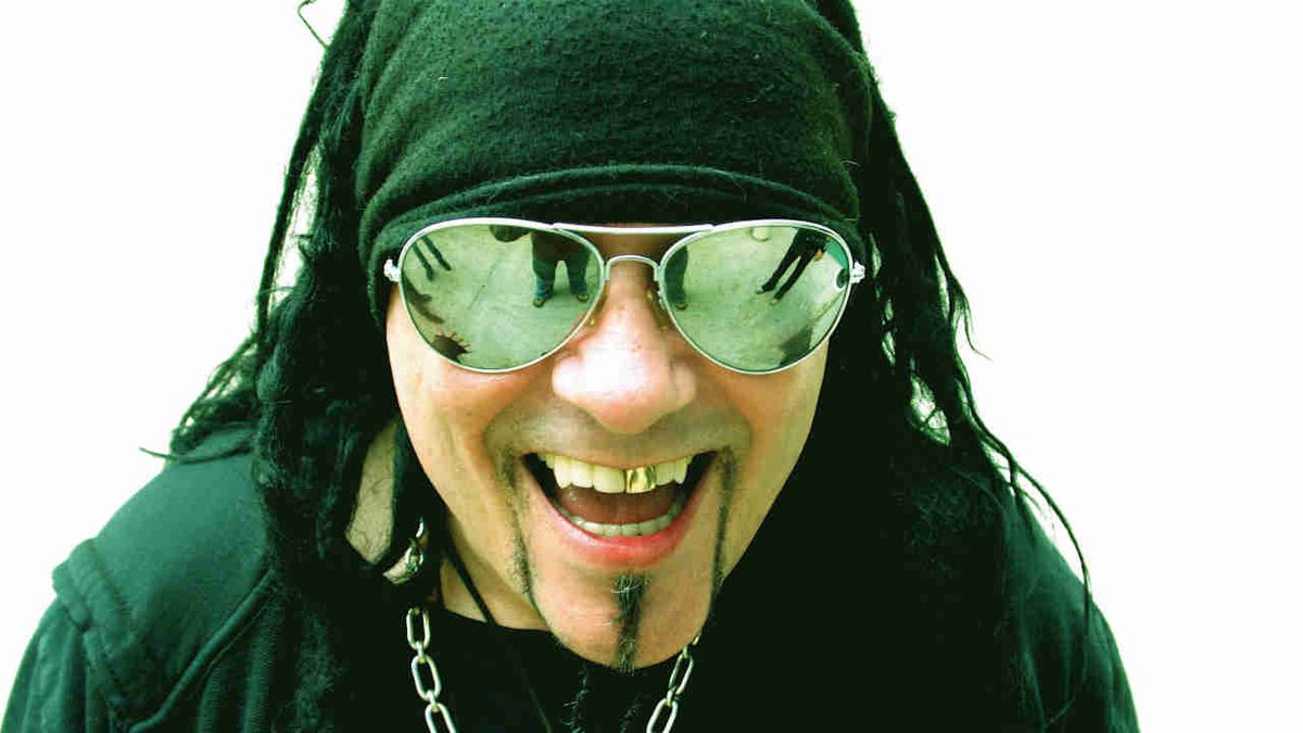 Ministry’s Al Jourgensen posing for a photograph in mirrored sunglasses