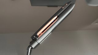 The Panasonic EH-HS99 hair straightener locked and closed on a glass countertop