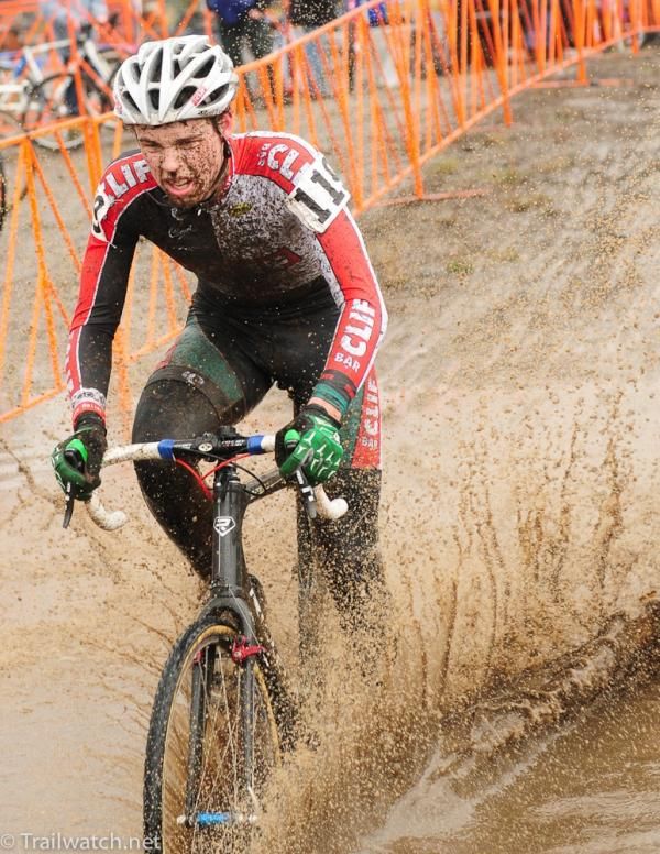 A Cliff Bar rider passes through a pond that developed due to the bike wash