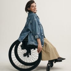 A woman in a wheelchair wearing anthropologie adaptive clothing